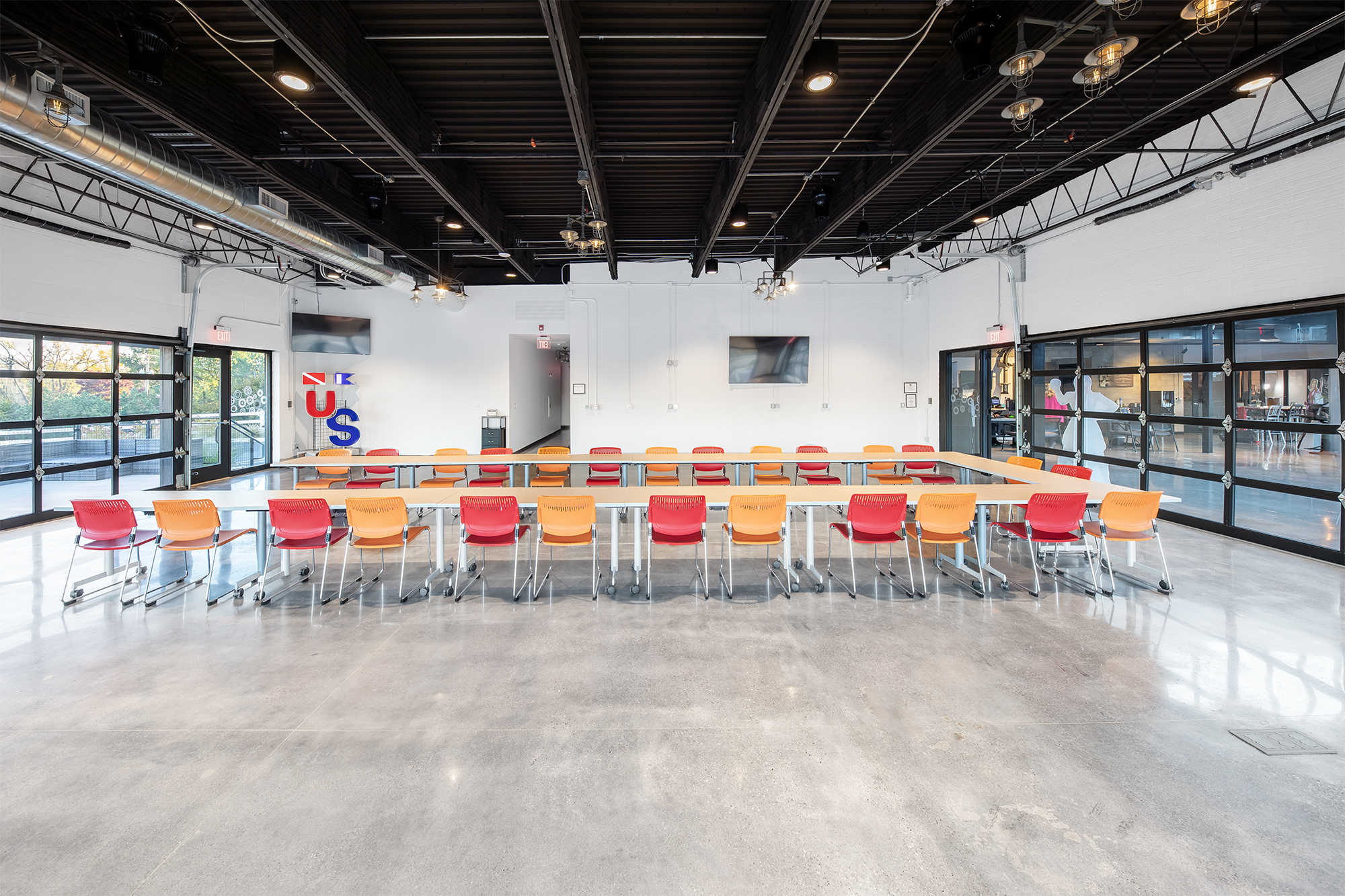 The event room at the Rochester location, with a long table and chairs along the side