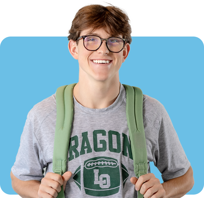 Teenage boy with glasses and t-shirt, smiling while holding his backpack straps